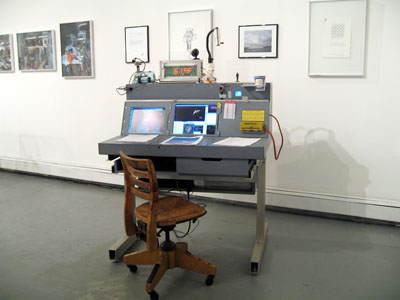 Exhibition View BPL Brower Propulsion Laboratory: Steven Brower, Parker's Box, 2007.
Portable Mission Control Console, 2007, aluminum, plastic, and wood console with computers, television, telephone, modem, printer, clock, special Carl Sagan lamp, cup holder, cameras, radio equipment, and napkins, 46