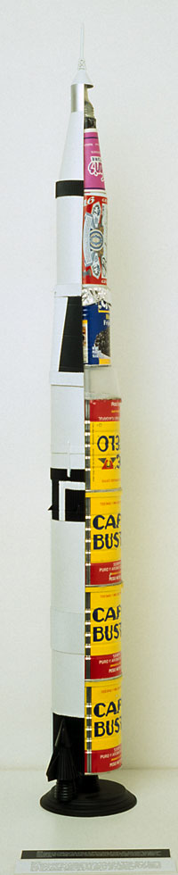 Saturn V Rocket, 2000, displaying various kinds of fuel necessary for artistic endeavor.  Work now missing.